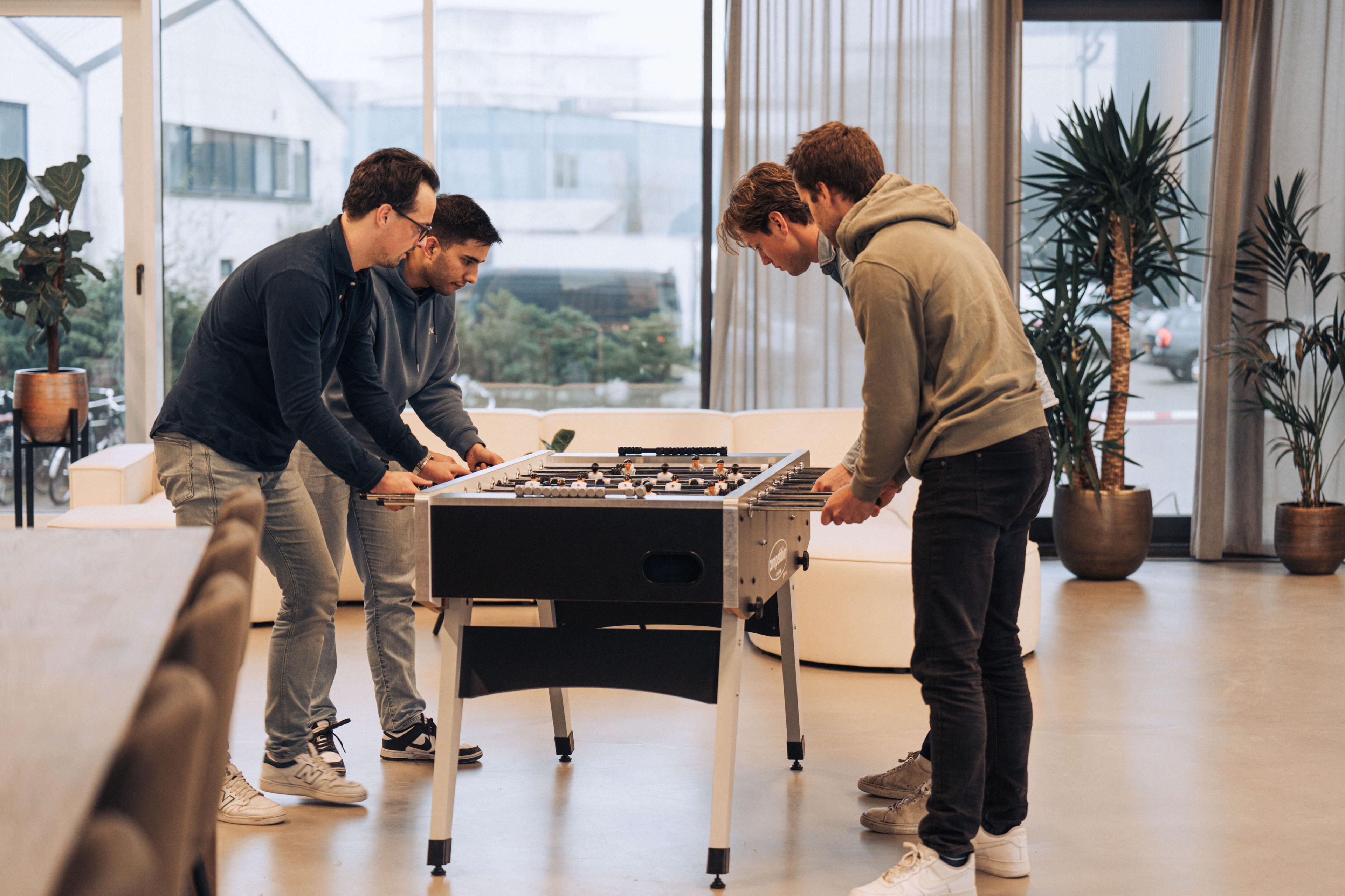 Employees playing table football